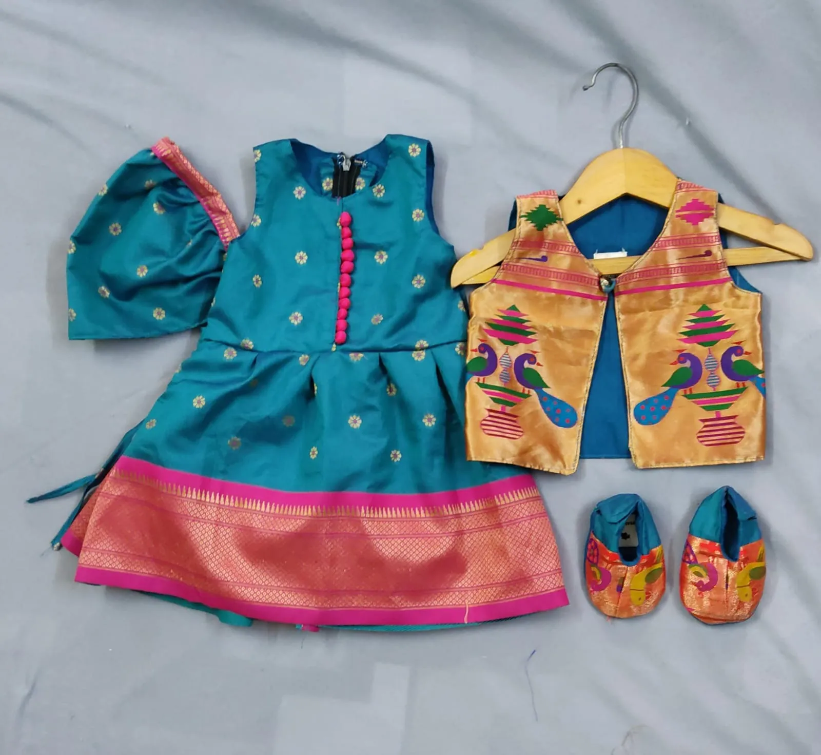 Girls premium turquoise blue paithani frock with golden Jacket with pink border